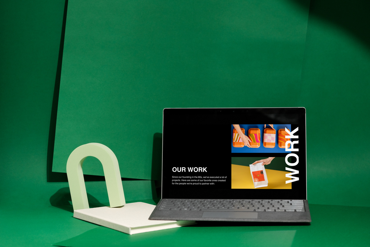 Design Branding Mockup on Laptop on Green Background